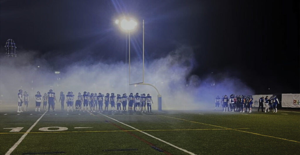 Photo retouch of seniors night with smoke on the filed.